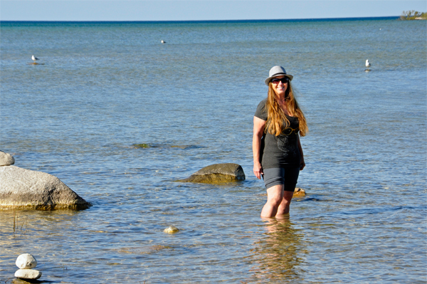 Karen Duquette walks in the water at Grand Traverse Bay